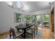 Dining room with wood floors, modern furnishings, and access to an outdoor deck at 106 Mill Rock Ct, Carrboro, NC 27510
