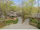 An aerial view displays the home's private driveway, lush landscaping, and mature trees at 106 Mill Rock Ct, Carrboro, NC 27510