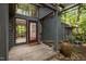 The covered entrance features a wooden deck and pergola with mature landscaping at 106 Mill Rock Ct, Carrboro, NC 27510
