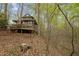 Exterior showing the wood paneled home with a backyard sloping downhill at 106 Mill Rock Ct, Carrboro, NC 27510