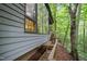 View of a home featuring a wooden walkway, big windows, and a tranquil natural setting at 106 Mill Rock Ct, Carrboro, NC 27510