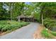 Beautiful home with lush greenery, a winding gravel driveway, and tranquil surroundings at 106 Mill Rock Ct, Carrboro, NC 27510