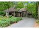 Charming gray home featuring a covered entrance and surrounded by lush greenery at 106 Mill Rock Ct, Carrboro, NC 27510