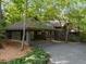 Inviting home exterior with lush landscaping, a carport, and a gravel driveway creating a warm, natural feel at 106 Mill Rock Ct, Carrboro, NC 27510