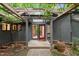 Inviting front entrance with a pergola and charming red door at 106 Mill Rock Ct, Carrboro, NC 27510