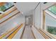 Well-lit hallway with skylights and glass railings providing plenty of natural light at 106 Mill Rock Ct, Carrboro, NC 27510