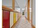 Hallway with a tiled floor and unique colorful wood cabinetry at 106 Mill Rock Ct, Carrboro, NC 27510