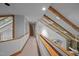Hallway features carpet, wooden handrail, skylight, and glass railing overlooking lower level at 106 Mill Rock Ct, Carrboro, NC 27510