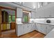 Bright kitchen with white cabinets, sleek countertops, and a view of lush greenery at 106 Mill Rock Ct, Carrboro, NC 27510