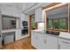 Contemporary kitchen showcasing white cabinets, built-in ovens, and an adjacent eating nook at 106 Mill Rock Ct, Carrboro, NC 27510