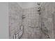 Accessible tiled shower is equipped with seating, grab bars, and mounted bath and body products at 106 Mill Rock Ct, Carrboro, NC 27510
