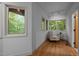 Bright sun room offers an armchair, hardwood floors, a table, and abundant nature views at 106 Mill Rock Ct, Carrboro, NC 27510