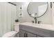 Bathroom with a gray vanity, black faucet, stylish mirror and decorative artwork on the wall at 10744 Cokesbury Ln, Raleigh, NC 27614