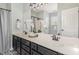 Double sink vanity with black cabinets, decorative mirror and fixtures, and stylish lighting at 10744 Cokesbury Ln, Raleigh, NC 27614