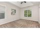 Neutral bedroom with a ceiling fan, artwork, and large windows providing lots of natural light at 10744 Cokesbury Ln, Raleigh, NC 27614