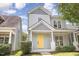 Charming two-story home features a bright yellow front door, inviting porch, and neatly landscaped yard at 10744 Cokesbury Ln, Raleigh, NC 27614