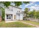 Two-story home with light gray siding, green lawn, and a brick walkway leading to a fenced yard at 10744 Cokesbury Ln, Raleigh, NC 27614