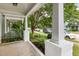 Relaxing front porch with a swing and view of the landscaped yard and quiet residential street at 10744 Cokesbury Ln, Raleigh, NC 27614