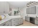 Bright and airy kitchen offers a modern aesthetic with gray cabinets and light countertops at 10744 Cokesbury Ln, Raleigh, NC 27614