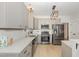 Modern kitchen features stainless steel appliances, light countertops, and gray cabinetry at 10744 Cokesbury Ln, Raleigh, NC 27614