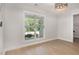 Bright room with hardwood floors, a large window, and modern decor offers a versatile space at 10744 Cokesbury Ln, Raleigh, NC 27614