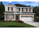Charming two-story home featuring a brick veneer, gray siding, black shutters, and a well-manicured lawn at 1104 Landen Creek Ln, Zebulon, NC 27597