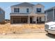 Two-story home under construction showing brick facade and an attached two-car garage at 1104 Landen Creek Ln, Zebulon, NC 27597
