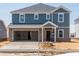 Two-story home featuring a two-car garage, brick accents, and modern architecture at 1108 Landen Creek Ln, Zebulon, NC 27597