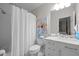 Clean bathroom featuring shower, marble vanity, neutral paint, modern fixtures, and updated décor at 1112 Blenheim Dr, Raleigh, NC 27612