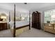 Well-lit bedroom with four-poster bed, shuttered windows, and beautiful decor at 1112 Blenheim Dr, Raleigh, NC 27612