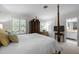 Bright bedroom with large windows, a four-poster bed, and an attached bathroom at 1112 Blenheim Dr, Raleigh, NC 27612
