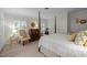 Bright bedroom features four poster bed, patterned chair, neutral walls, and plenty of natural light at 1112 Blenheim Dr, Raleigh, NC 27612