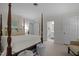 Bedroom showcases a four poster bed, neutral decor, ensuite bathroom and bright natural light at 1112 Blenheim Dr, Raleigh, NC 27612