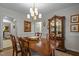 Dining room with elegant china cabinet and access to multiple rooms at 1112 Blenheim Dr, Raleigh, NC 27612
