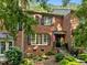 Charming brick two-story home with black shutters and manicured landscaping at 1112 Blenheim Dr, Raleigh, NC 27612