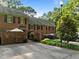 Brick townhome with well-maintained landscaping, rear driveway, and private patio at 1112 Blenheim Dr, Raleigh, NC 27612