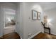 Light and airy hallway with hardwood floors and decorative wall art at 1112 Blenheim Dr, Raleigh, NC 27612