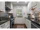 Kitchen with white cabinets, stainless steel appliances and black countertops at 1112 Blenheim Dr, Raleigh, NC 27612