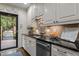 Kitchen featuring white cabinets, dark countertops and stainless steel dishwasher at 1112 Blenheim Dr, Raleigh, NC 27612