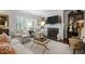 Bright living room with fireplace, shuttered windows, and neutral color palette at 1112 Blenheim Dr, Raleigh, NC 27612