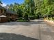 Asphalt parking area in front of brick townhomes and mature trees at 1112 Blenheim Dr, Raleigh, NC 27612