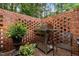The patio includes a stainless steel grill and brick privacy wall surrounded by greenery at 1112 Blenheim Dr, Raleigh, NC 27612