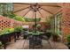 Patio with brick privacy wall, outdoor grill, and comfortable seating area at 1112 Blenheim Dr, Raleigh, NC 27612
