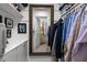 Organized walk-in closet featuring shelves, hanging racks, and a mirrored door at 1112 Blenheim Dr, Raleigh, NC 27612