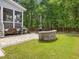 Backyard patio with built-in seating, grill, and wooded views at 1148 Tringham Ct, Apex, NC 27502