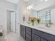 Bright bathroom with double vanity, gray cabinets, and white countertops at 1148 Tringham Ct, Apex, NC 27502