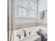 Bright bathroom featuring a large tub, shower, and towel rack at 1148 Tringham Ct, Apex, NC 27502