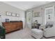Bright Bedroom features a wood dresser, a glider, and lots of natural light from the two windows at 1148 Tringham Ct, Apex, NC 27502
