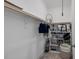 Walk-in closet featuring hanging racks, shelving, and overhead storage for organization at 1148 Tringham Ct, Apex, NC 27502