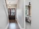 Entryway with hardwood floors, a decorative light fixture, and a view into the bedroom at 1148 Tringham Ct, Apex, NC 27502